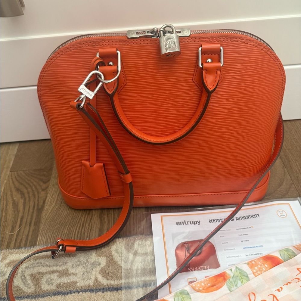 Authentic Louis Vuitton Orange Alma bag in like new condition. Full set!